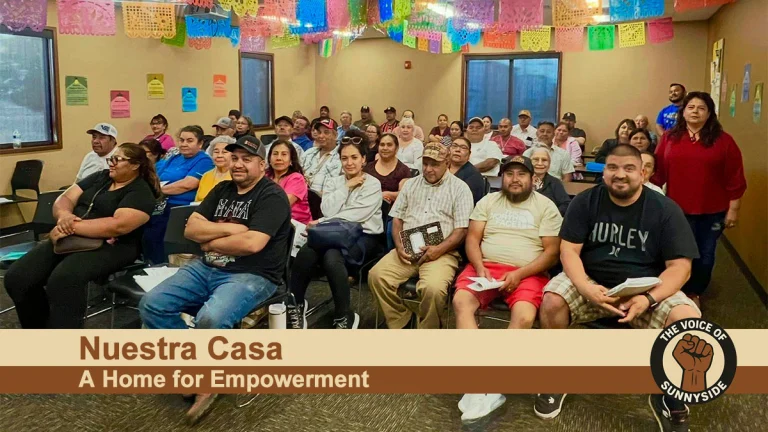 Community members attending a Nuestra Casa educational session in Sunnyside, WA, seated under colorful papel picado banners.
